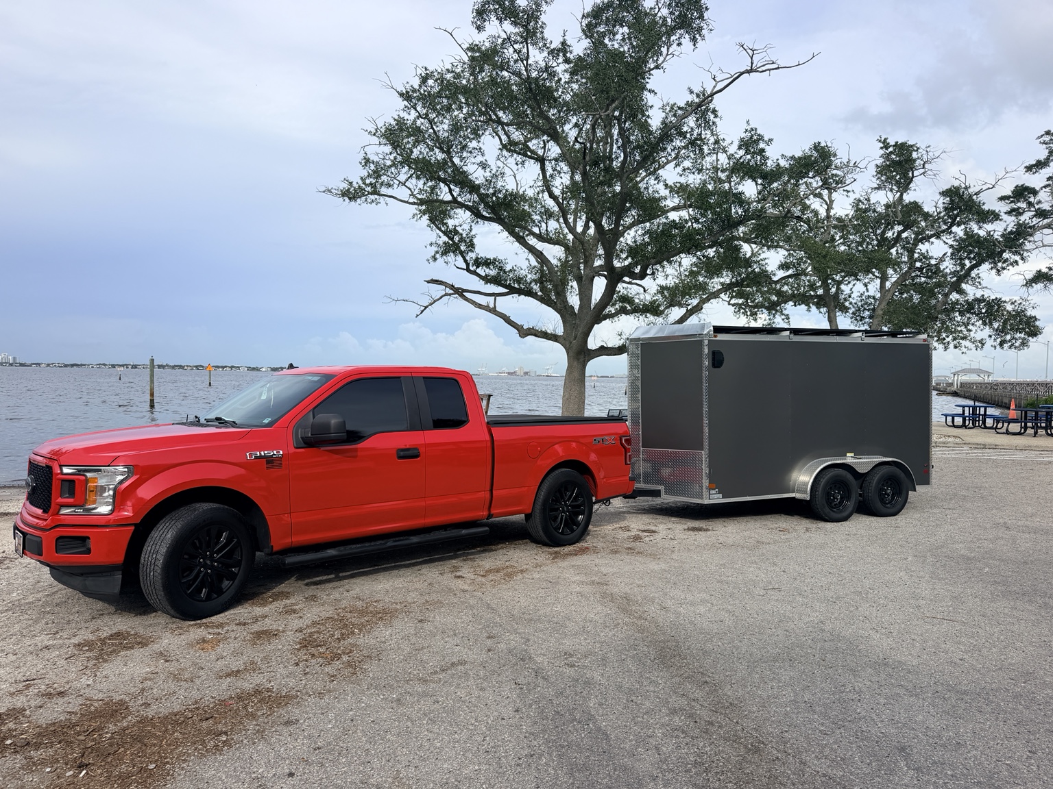 Shipshape Auto Solutions red Ford F-150 and gray mobile service trailer