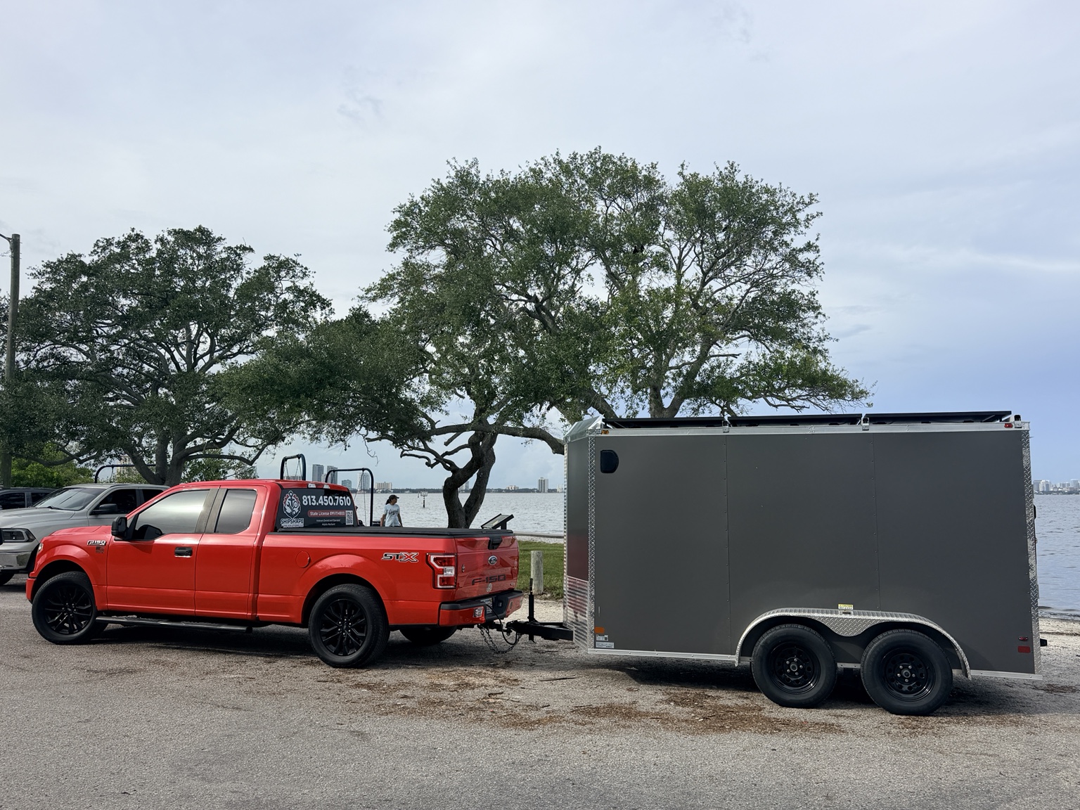Shipshape red F-150 towing gray tandem axle mobile service trailer